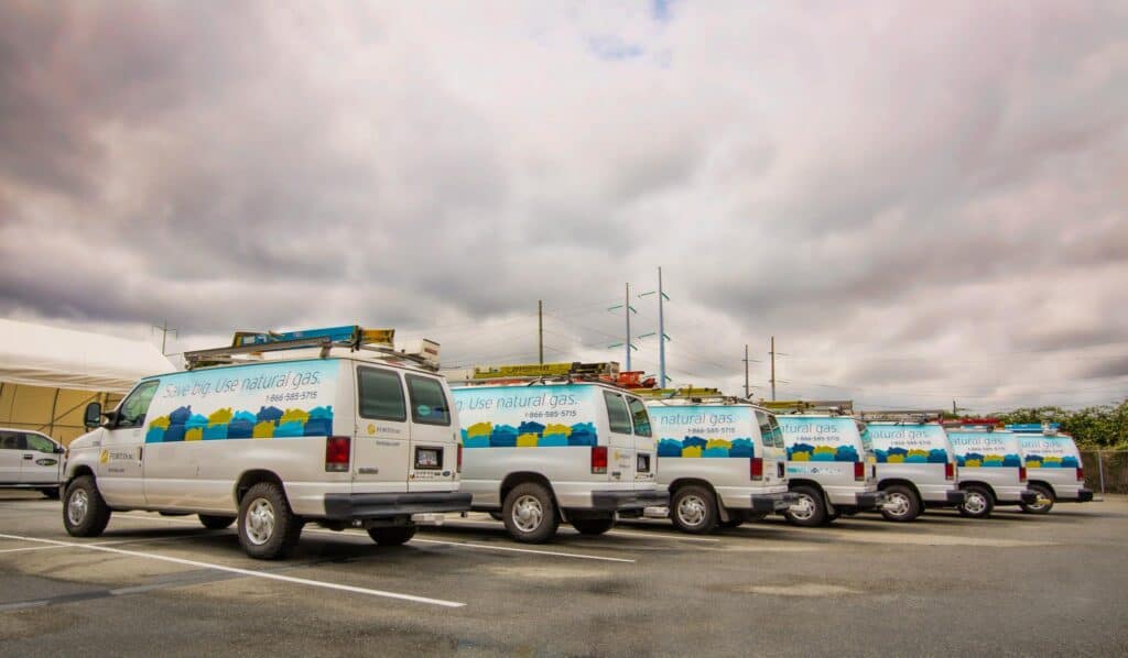 Vehicles with custom signage for natural gas use in Victoria.