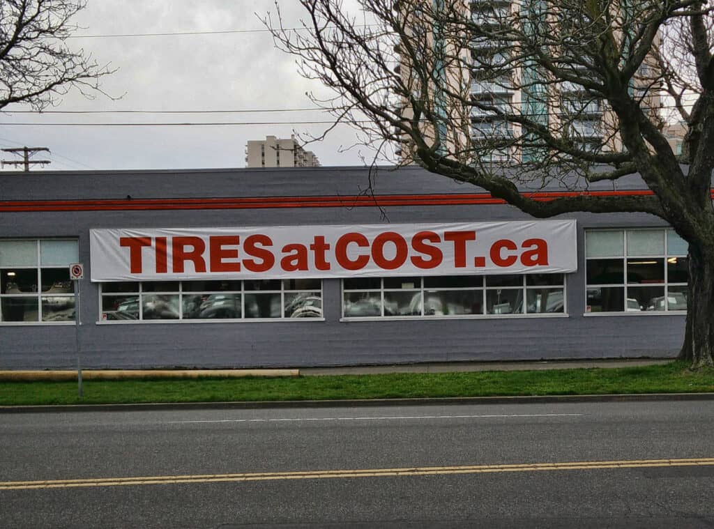 Large outdoor banner advertising tires at affordable prices.