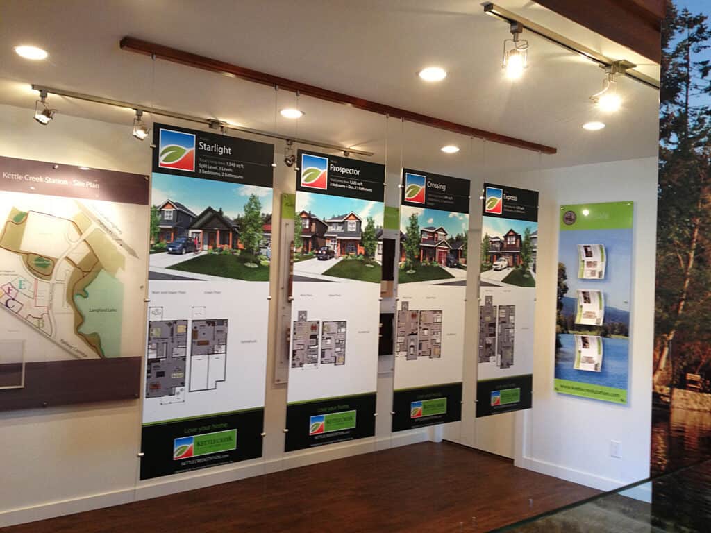 Property development signage display with multiple project boards in interior setting.