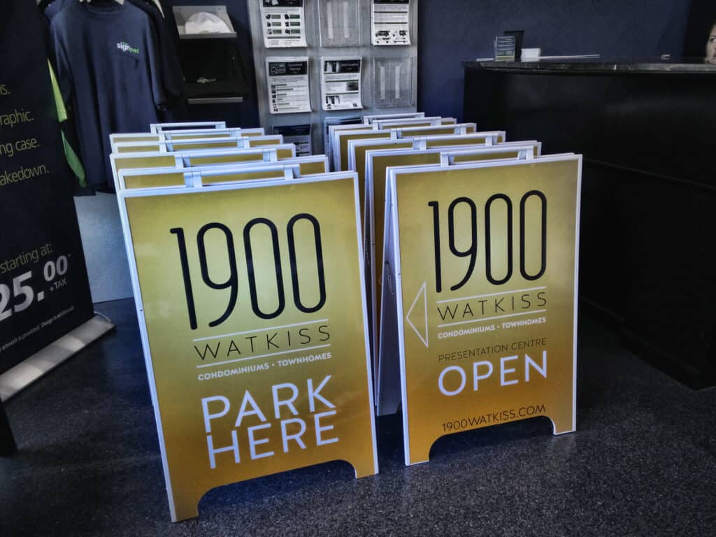 Outdoor real estate sign promoting the 1900 Watkiss property with "Park Here" and "Open" messages.