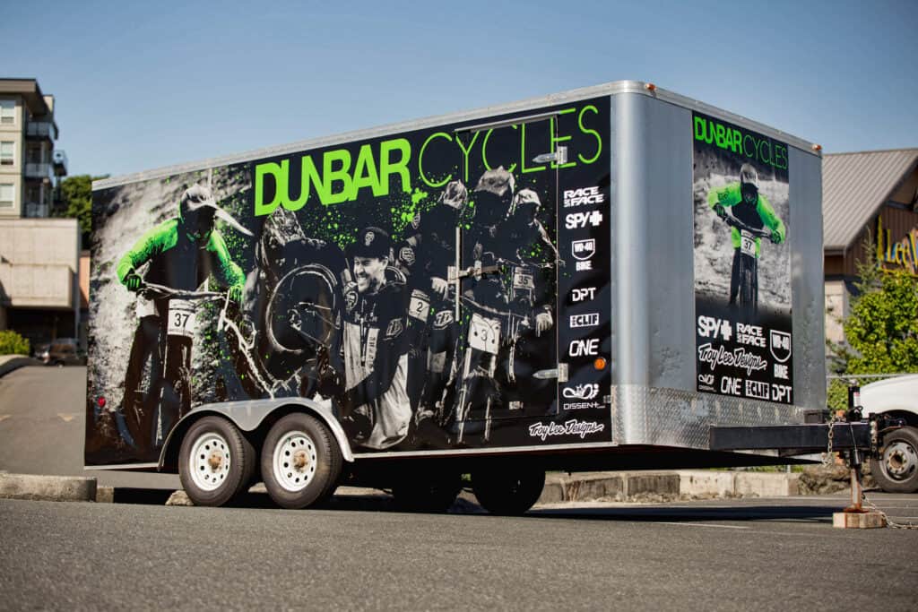 Mobile advertising trailer for DUBAR CYCLES with cycling event graphics.