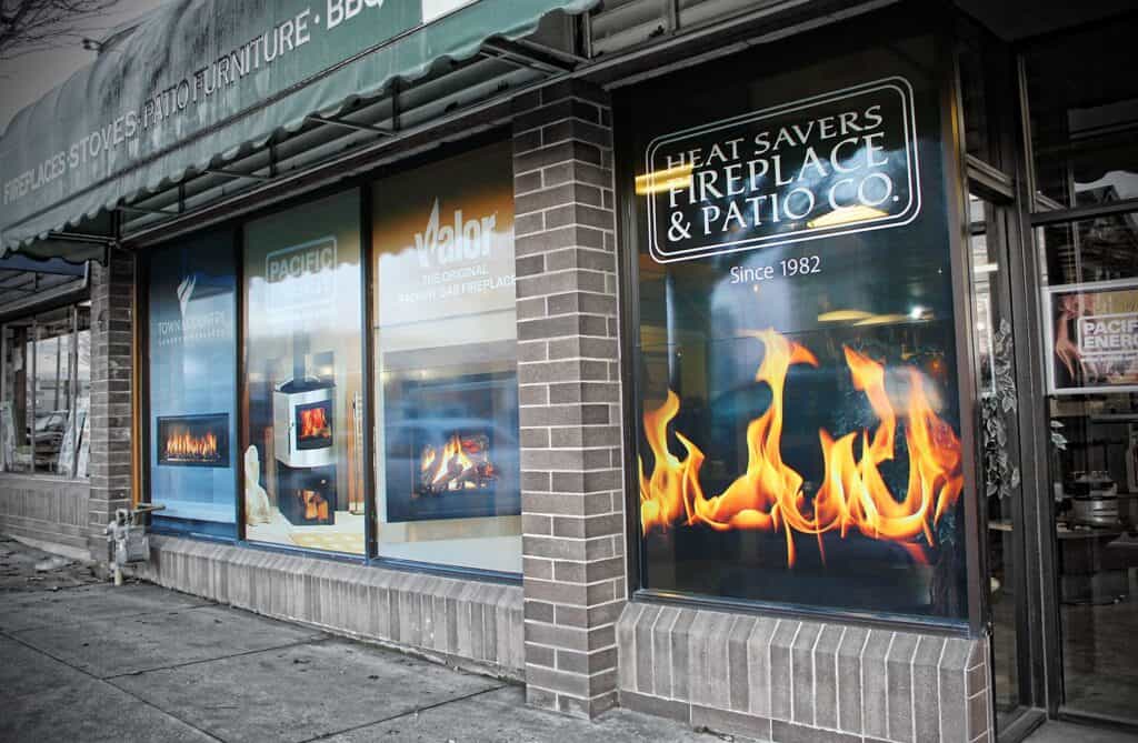 Fireplace & Patio Sign with flames graphic, promoting heat-saving solutions.