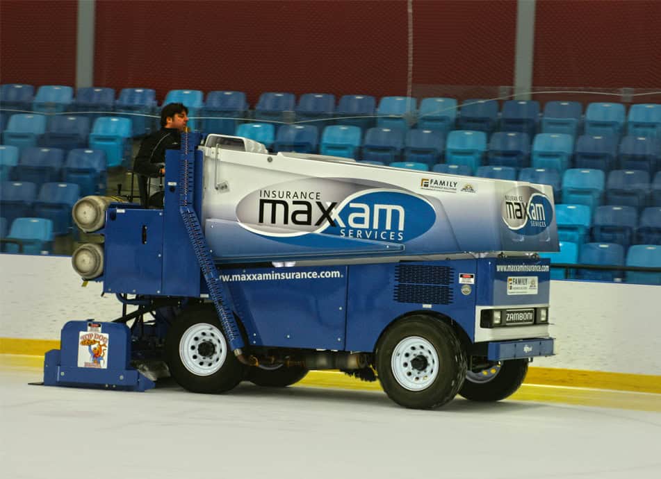 Ice resurfacing machine with Maxam Insurance branding on the ice rink.
