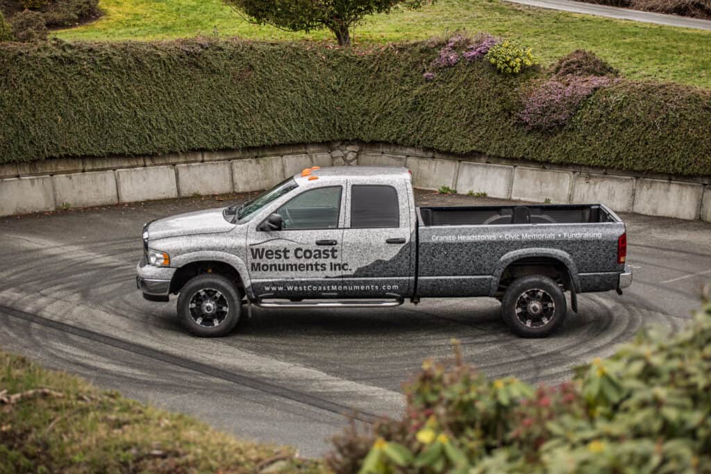 Vehicle wrap showcasing West Coast Monuments Inc. branding in Victoria.