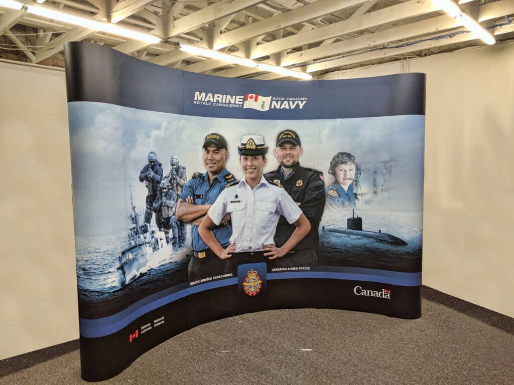 Custom Marine Navy recruitment sign with personnel images and Canadian flags.