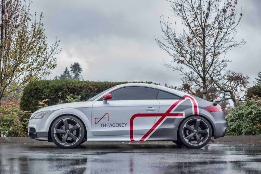 Custom vehicle wrap featuring The Agency branding on a silver car in Victoria.